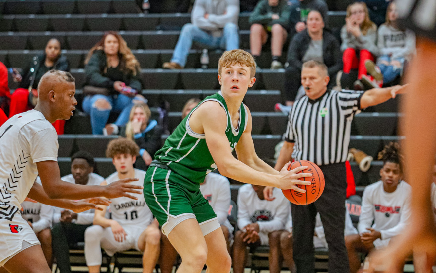boy looking to shoot ball as other team looks to steal the ball
