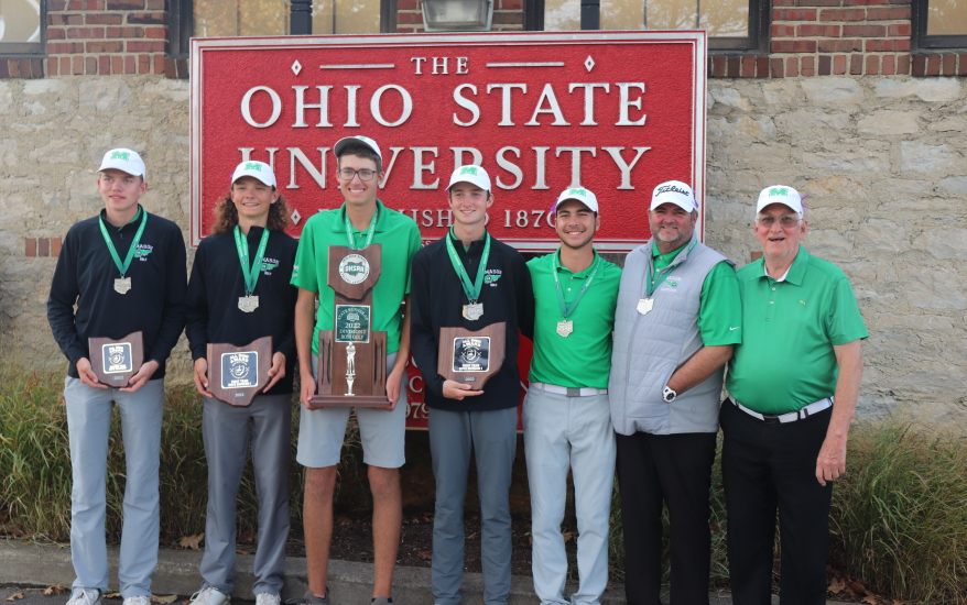 team in front of "Ohio State University" sign holding trophies
