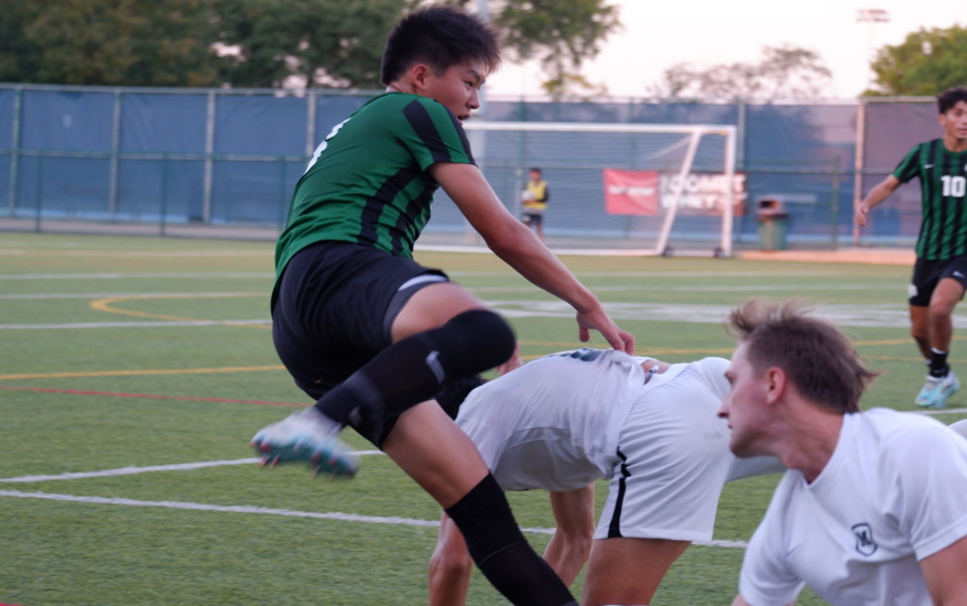 Mason mid kick as another player falls 