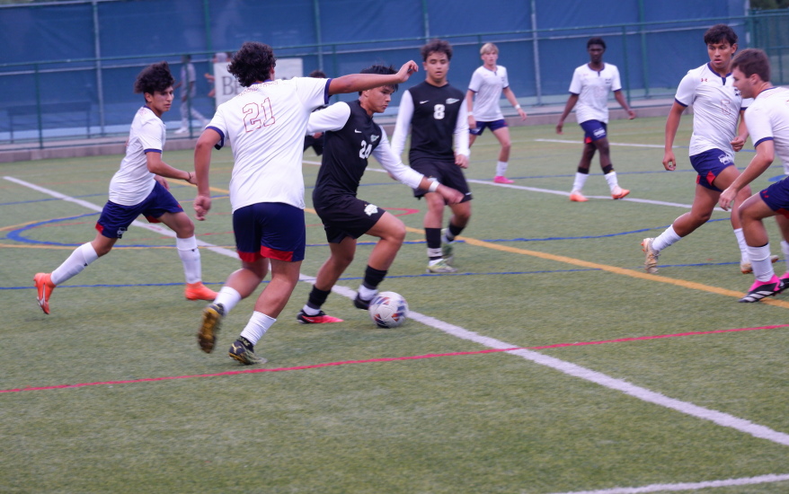 24 preparing to kick, surrounded on all sides by opponents