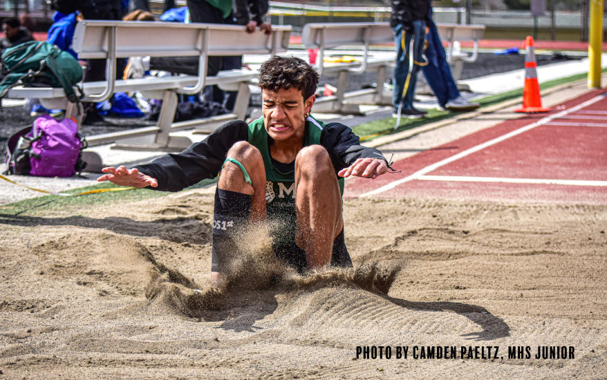 long jumper landing in the sand