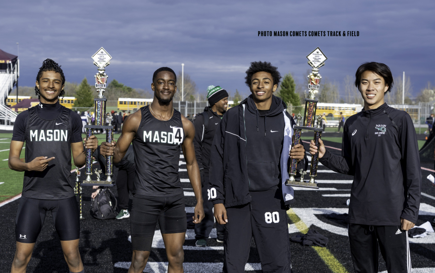 boys holding trophies for track and field