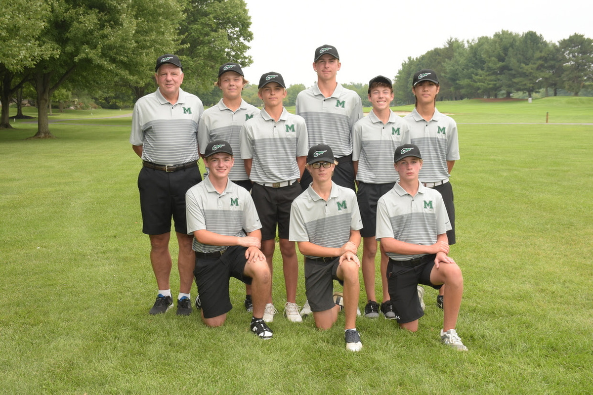 Boys golf team and coach on the golf course