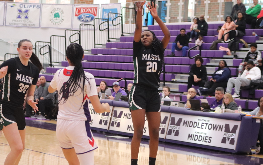 girl shooting ball and other girls defending and blocking