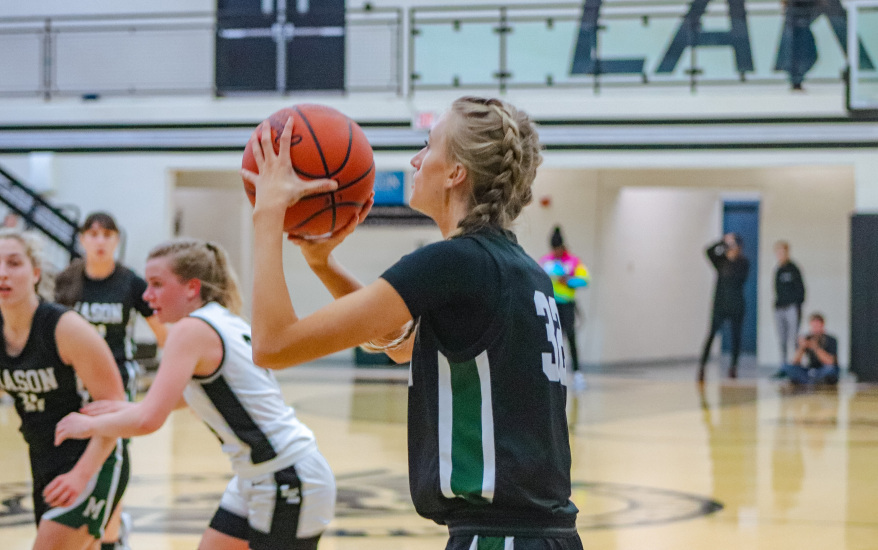 girl shooting basketball
