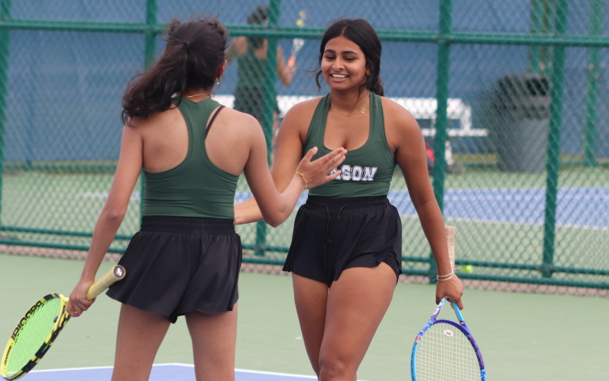 Two Mason girls high five after match