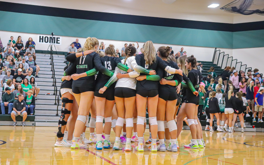 Volleyball team huddling