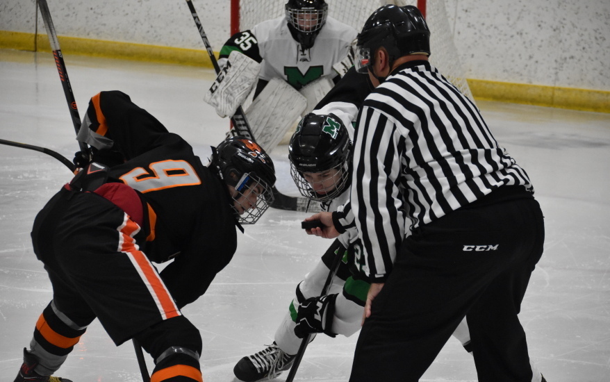 hockey player and ref in starting position