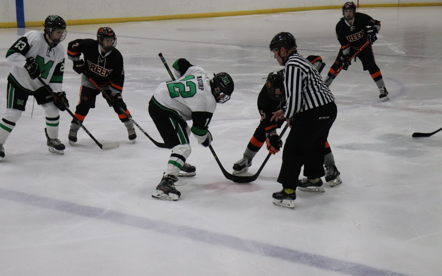 hockey player and ref on ice